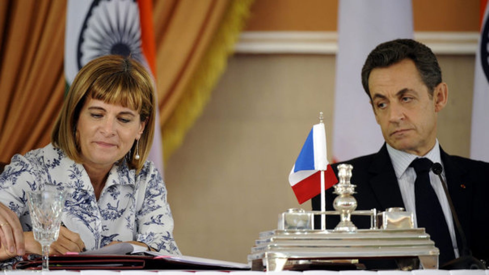 France's President Sarkozy watches as Areva's CEO Lauvergeon signs documents at Hyderabad House in New Delhi